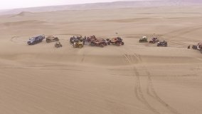 Aerial video of sports in dunes. UTV and quad bike