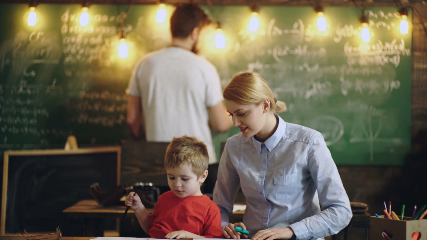 Family doing homework together at home. Teachers Day. Teacher parents helping child pupil studying in classroom. Parenting and kids Royalty-Free Stock Footage #1058856775