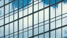 Time lapse of blue sky and clouds reflected in structural modular glass wall.  - Powered by Shutterstock - Get 15% off with code: PIKWIZARD15