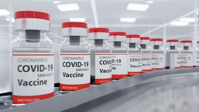 COVID-19 vaccine has been developed and ampoules with coronavirus vaccine moves to the packing on the pharmaceutical production line. It's for injecting medical professionals and people at risk, loop - Powered by Shutterstock - Get 15% off with code: PIKWIZARD15