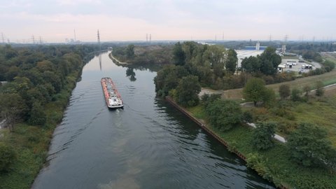 Aerial view of tanker barge navigating up the rhine herne canal.