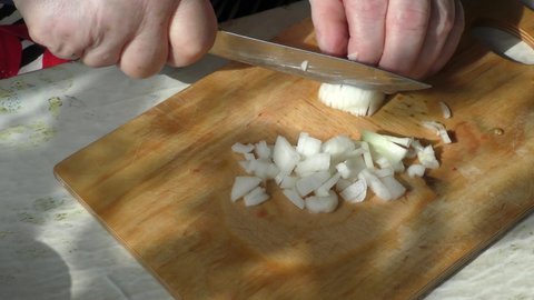 the chef cuts onions with a knife