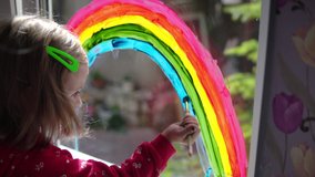 Girl draws a rainbow with paints on the window - Powered by Shutterstock - Get 15% off with code: PIKWIZARD15