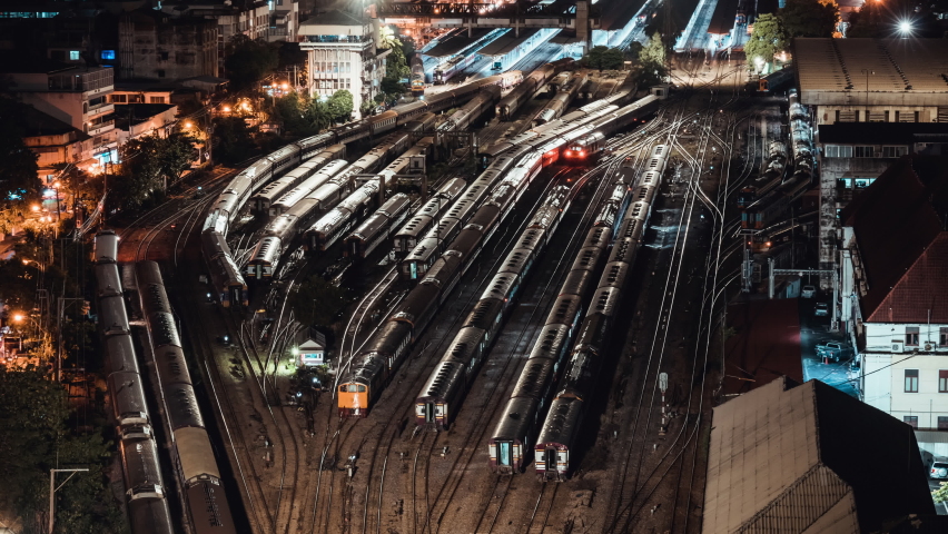 Time-lapse of old trains parking in rail yard at Hua Lamphong train station in Bangkok city, Thailand. Railway transportation concept. High angle view, tilt up then still Royalty-Free Stock Footage #1058880883