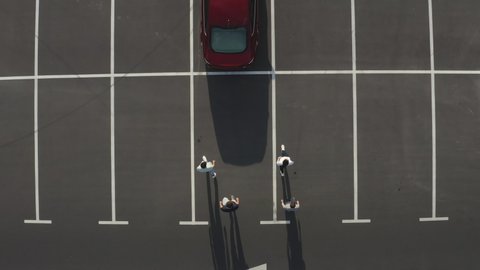 The upper view on the four people getting in the car