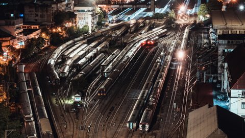 Time-lapse of old trains parking in rail yard at Hua Lamphong train station in Bangkok city, Thailand. Railway transportation concept. High angle view, zoom out then still