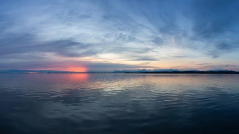 Cinemagraph Continuous Loop Animation. View of the Calm Water on the Pacific Ocean Coast during a colorful cloudy sunset. Taken in White Rock, Vancouver, British Columbia, Canada.