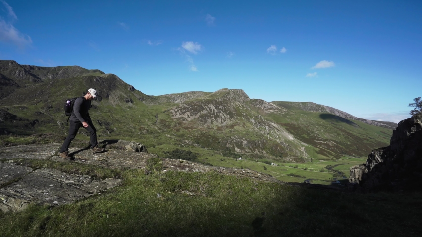 Man walking in the mountains with blue sky