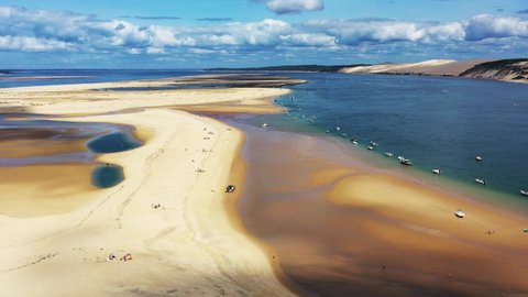 Banc d'Arguin in Arcachon Bay France with boats stationed in a row along the sandbank, Aerial flyover view