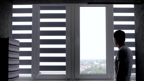 Man installing cassette roller blinds on windows