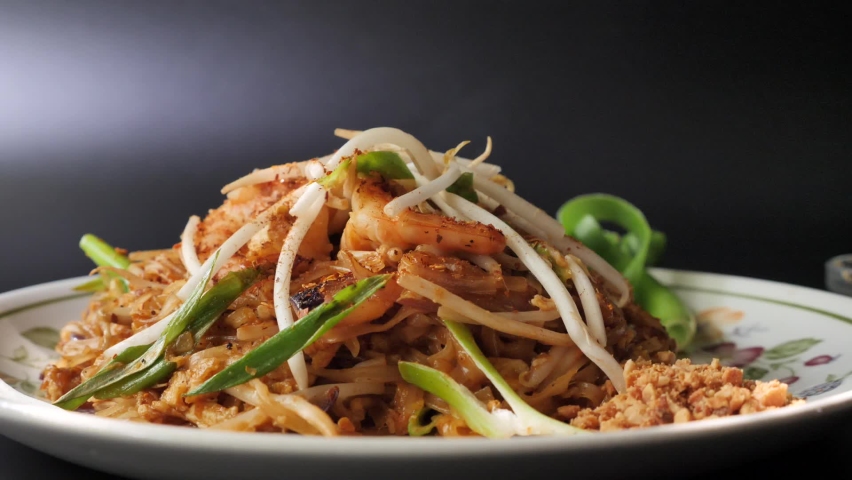 Hand Squeezing a Piece of Fresh Green Lime on Prawn Pad Thai Royalty-Free Stock Footage #1058908052
