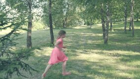 A group of girls plays in the park in summer, the competition is faster. 4K video. Summer park.