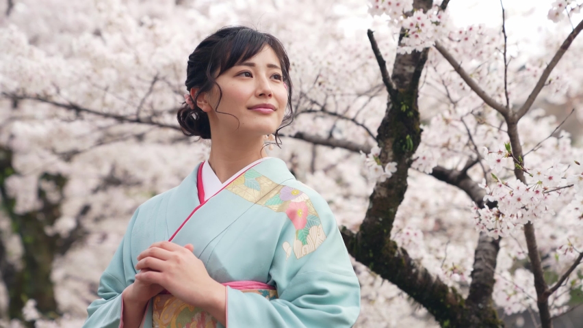 Young asian woman wearing kimono. Cherry blossoms. Japanese traditional clothes. Royalty-Free Stock Footage #1058911253