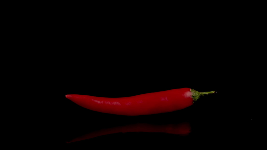 Hot red chili pepper in flames on a black background. Spicy food concept. Slow motion 120 fps | Shutterstock HD Video #1058912081