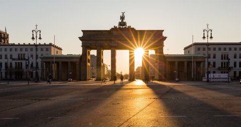 Brandenburg Gate sunrise timelapse with sunrays and shadows in Berlin, Germany