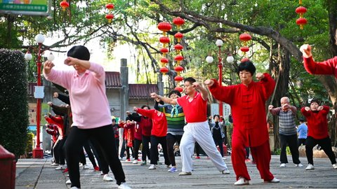 ZHONGSHAN CHINA-December 20, 2019:elder Chinese people doing Tai Ji exercise in a park in the morning.