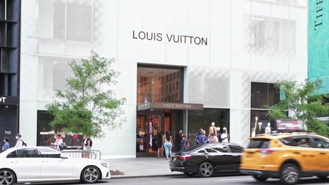 New York, New York, USA - September 12, 2020: Louis Vuitton store on Fifth Avenue in Manhattan. People and vehicles can be seen.