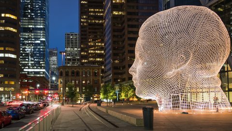 Calgary, Canada - September 12, 2020: Timelapse view of Downtown Calgary showing popular landmark Wonderland sculpture at dusk in Calgary, Alberta, Canada. 