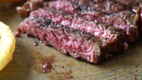 sliced beef steak on wood board