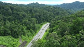 Footage 4k B-roll Aerial drone view of Southern Thailand Road with green jungle in Thailand.
