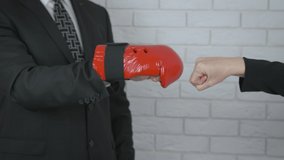 Contract in gloves. A man on boxing gloves touch the woman fists. A concept of a team work and makes business together. - Powered by Shutterstock - Get 15% off with code: PIKWIZARD15