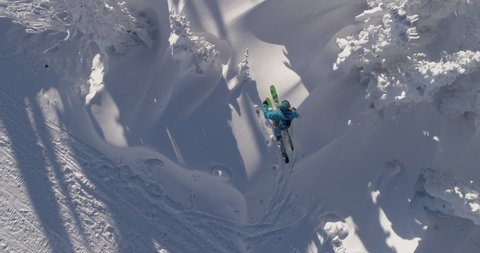 Aerial: Ski touring man crossing over the camera view. Ski touring in the mountains in winter season fresh snow. guy of ski touring on skin uphill in a line. Powder day. ski vacation travel concept Stockvideó