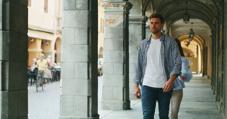 Authentic shot of an young happy romantic couple in love is having fun and enjoying time together in old city center in a sunny day.