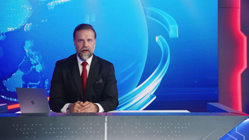 Live News Studio with Professional Male Newscaster Reporting on the Events of the Day. TV Broadcasting Channel with Presenter, Anchor Talking. Mock-up Television Channel Newsroom Set | Shutterstock HD Video #1058960816