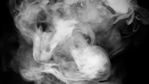 white smoke on a black background. Slow motion. Vape smoke. Texture of cigarette smoke cloud.
