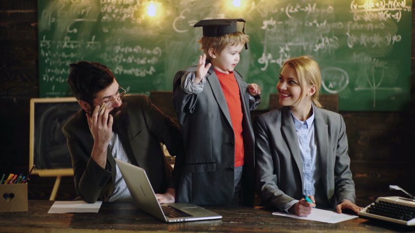 Family studying in class. Kid genius. Schoolboy boy and parents teachers studies at home and does school homework Royalty-Free Stock Footage #1058966627
