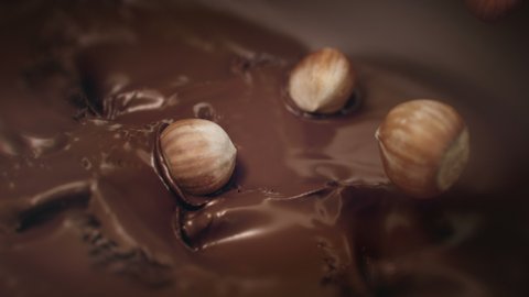 Hazelnuts Splashing Into Liquid Dark Chocolate in 4K Super slow motion