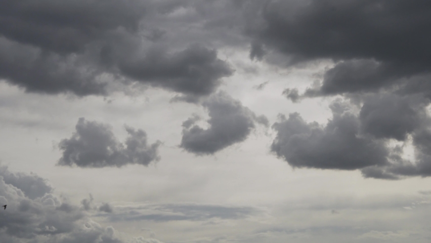 Black Gray Rain Clouds in the Sky, Cloudy Bad Weather, Humid Climate. Dramatic Sky. A Black Dark Gray Storm Cloud is Floating in the Sky. Royalty-Free Stock Footage #1058973011