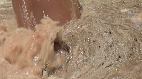 Torrent of sewage falling in a mountain of shit