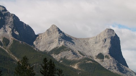 Tight Timelapse Shot of Canmore Mountains and Clouds, Ha-Ling Peak Mountain in Canmore Alberta. Beautiful Rocky Mountain Timelapse with Evergreen Trees