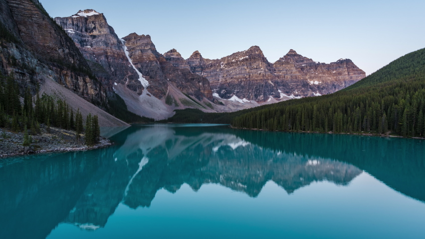 Zoom out timelapse view of sunrise over Moraine Lake and Valley of the Ten Peaks, Banff National Park, Alberta, Canada.  Royalty-Free Stock Footage #1058990165