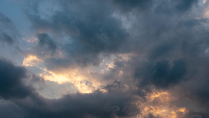 CLOUDS SHOWS THE IMPACT OF GLOBAL CLIMATE WARMING. Abstract clouds backgrounds. Dark dramatic clouds move fast. Ragged thunderclouds cover the sunny areas of the sunset sky. | Shutterstock HD Video #1058992769
