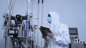 Worker science Technologist in white protective uniform with hairnet and mask operating on mask manufacture industrial to control produce and protective for virus,new normal concept.