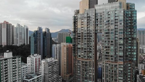 Aerial shot of Hong Kong high-risers buildings. Architecture in city. Skyscrapers downtown. Drone view of Kowloon skyline. Cityscape with windows. Popular financial destination in Asia. China. 