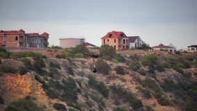 Silhouette of Professional photography drone copter with the panoramic camera rig flying in the sky. Aerial panoramic view of sunset over sea. Vehicle at sundown and copy space.