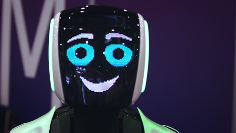 Beautiful portrait robot pulse heart on digital display pixel smile closeup looking at camera 4K. design sweet cyborg demonstrate 8 bit love. heart beat smiling android with feeling loving for people.