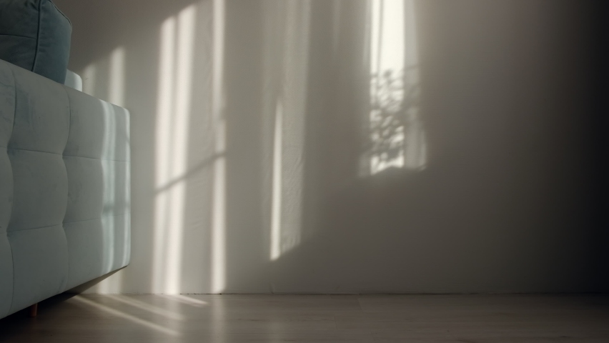 Morning sun lighting the room, shadow background overlays. Waving white tulle near the window. Royalty-Free Stock Footage #1059018164