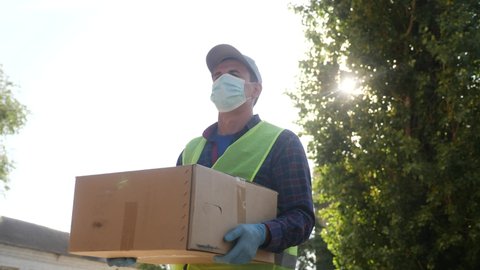 delivery pandemic coronavirus vaccine a goods and food product. courier delivery man covid delivers food to your home. parcel delivery concept. courier carries office boy box warehouse coronavirus
