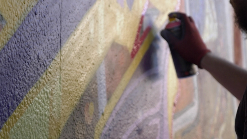 Spray Paint Wall Graffiti Art. Young man doing some spray painting on a wall in the street. Graffiti art | Shutterstock HD Video #1059020966