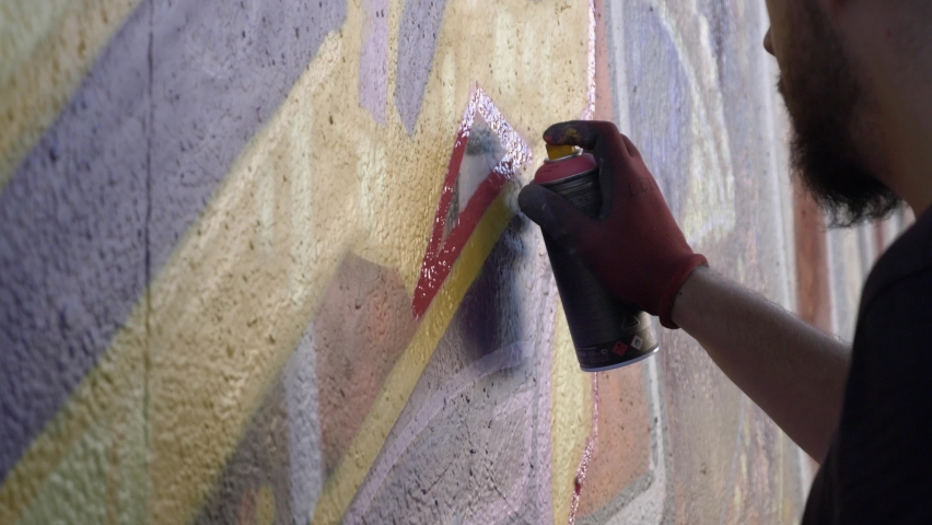 Spray Paint Wall Graffiti Art. Young man doing some spray painting on a wall in the street. Graffiti art Royalty-Free Stock Footage #1059020966