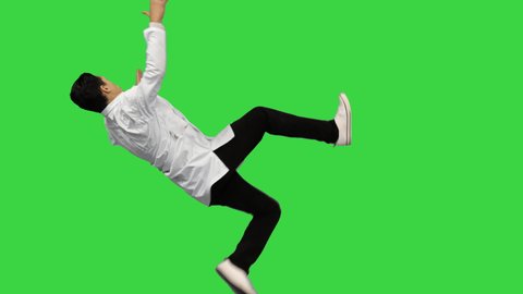 Young male doctor dancing breakdance, adjusting his robe looking at camera and then walking away on a Green Screen, Chroma Key.