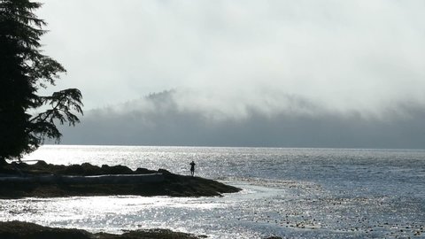 A man enjoys spending time by the Pacific ocean as the fog and tide roll in on a gorgeous summer afternoon!
