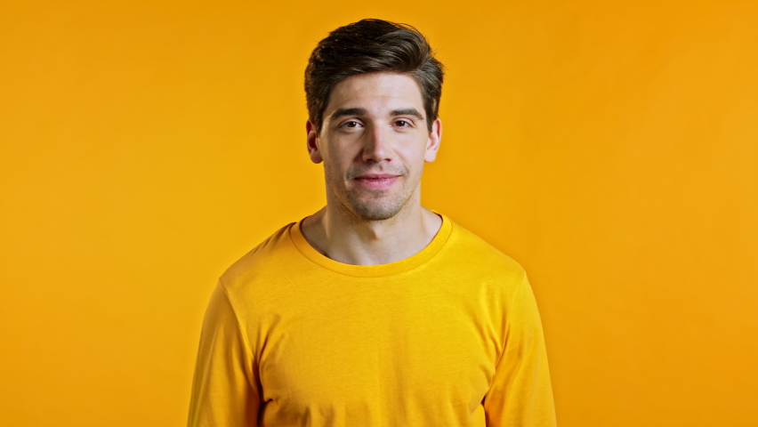 Happy european man dancing, showing yeah gesture of victory, he achieved result, goals. Surprised excited guy on yellow background Royalty-Free Stock Footage #1059048710