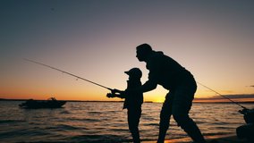 A man is helping his son with fishing at sunset - Powered by Shutterstock - Get 15% off with code: PIKWIZARD15