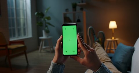 Close up shot of man holding a smartphone with chroma key mock up green screen - technology, connections, communications concept 4k video template