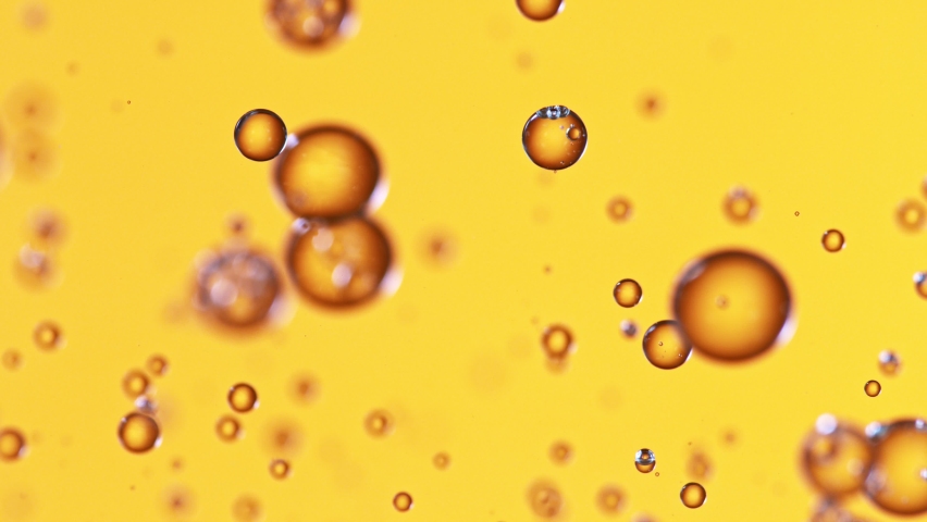 Super Slow Motion Shot of Oil Bubbles on Golden Background at 1000fps. Shoot on high speed cinema camera. Royalty-Free Stock Footage #1059054254